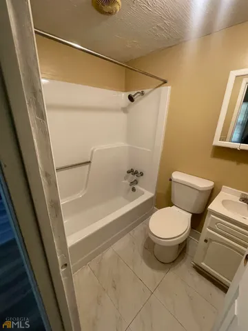 a bathroom with a toilet and a bathtub