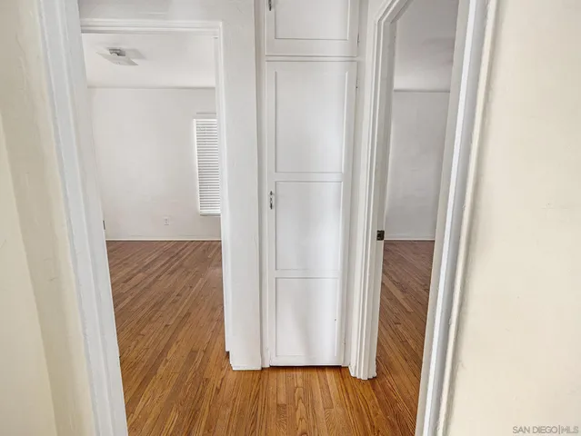 a view of a hallway with wooden floor