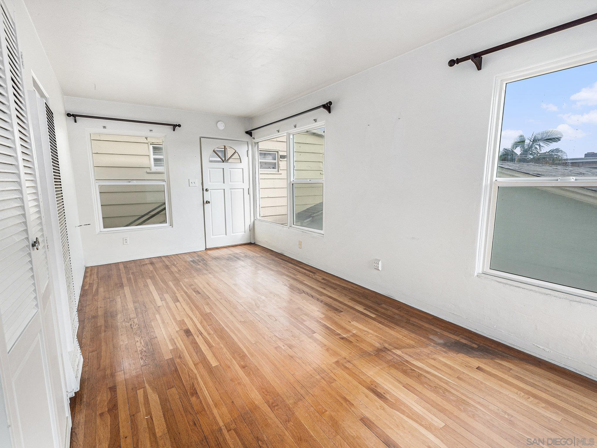 814 San Luis Rey Place San Diego, CA 92109 - Photo 13 of 29 a view of an empty room with a window and wooden floor