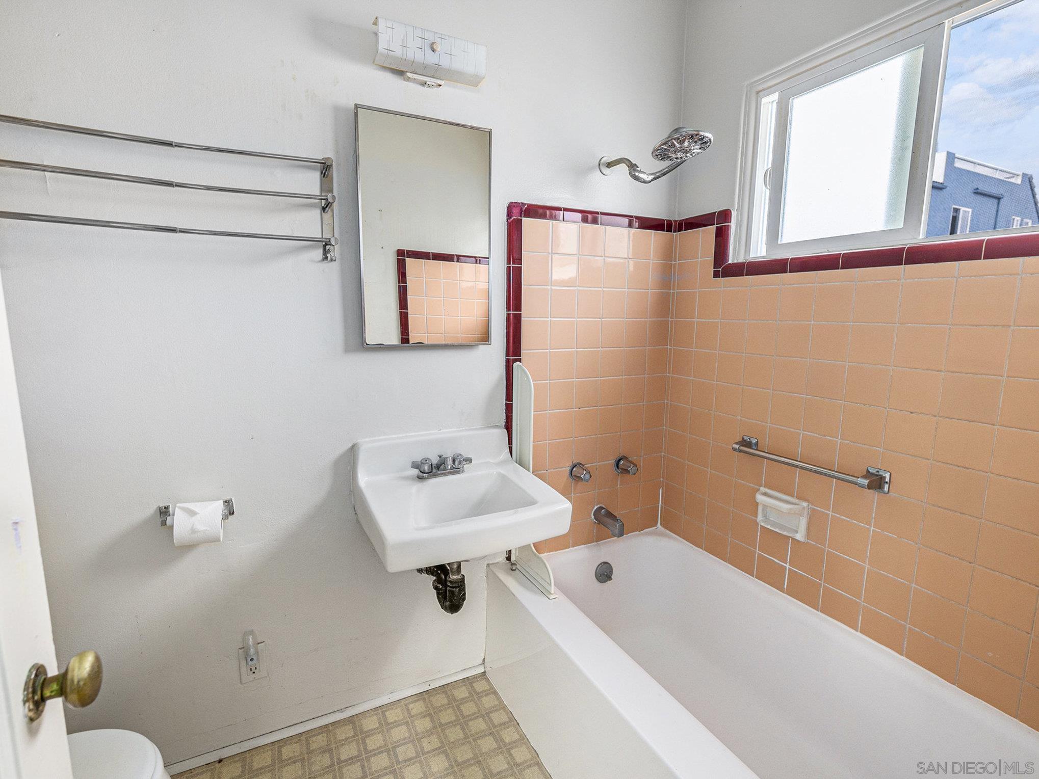 814 San Luis Rey Place San Diego, CA 92109 - Photo 16 of 29 a bathroom with a sink a toilet and a bathtub