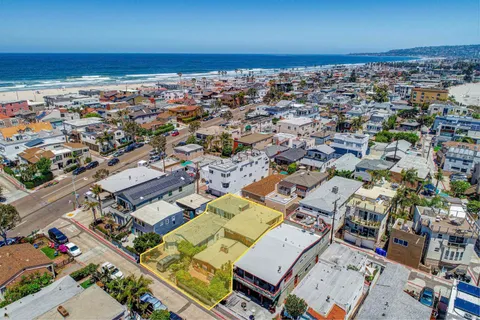an aerial view of a city with ocean view