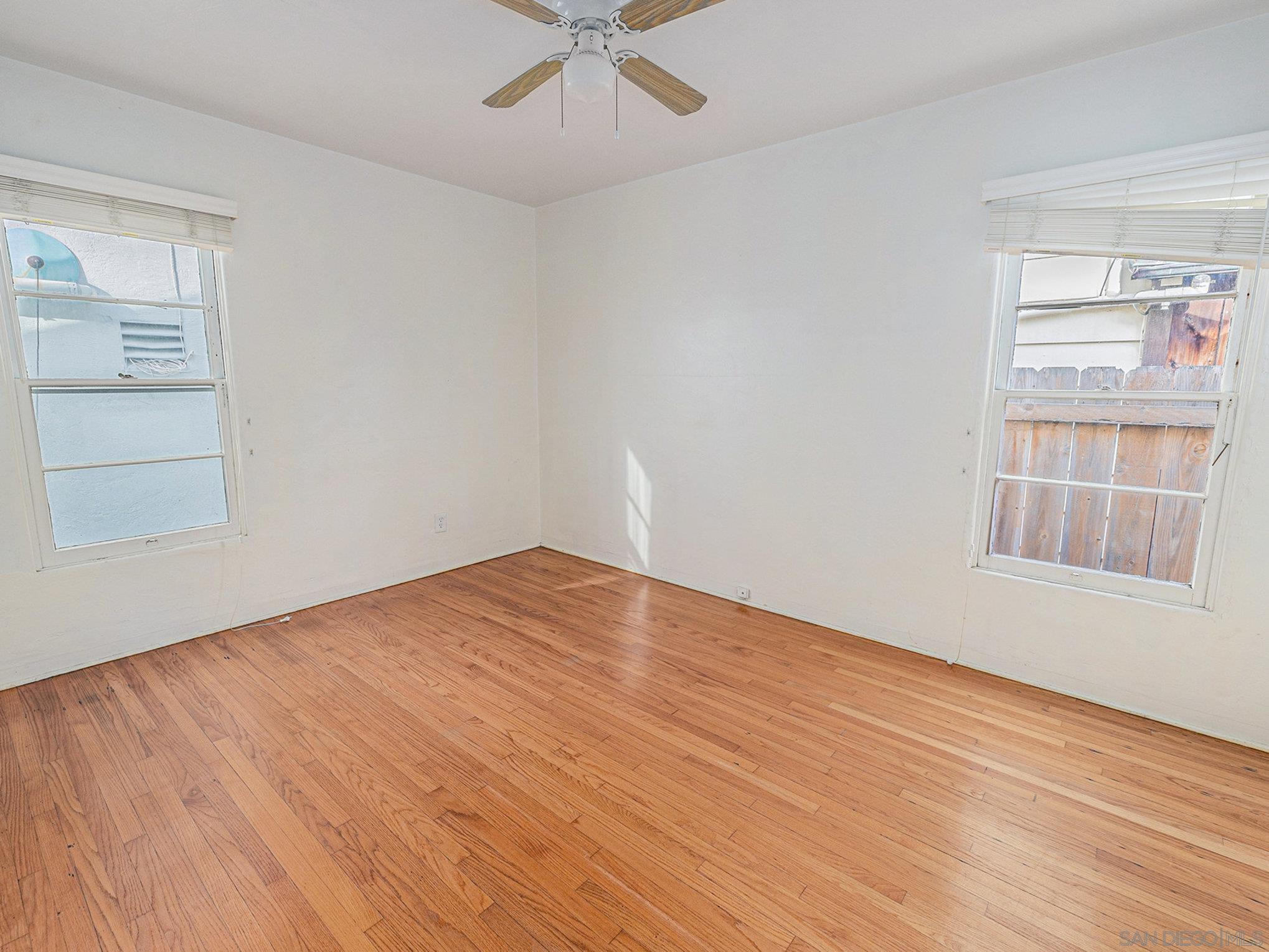 814 San Luis Rey Place San Diego, CA 92109 - Photo 9 of 29 wooden floor in an empty room with a window