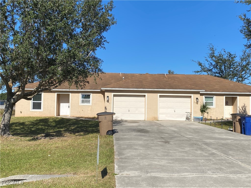 a front view of a house with a yard and garage