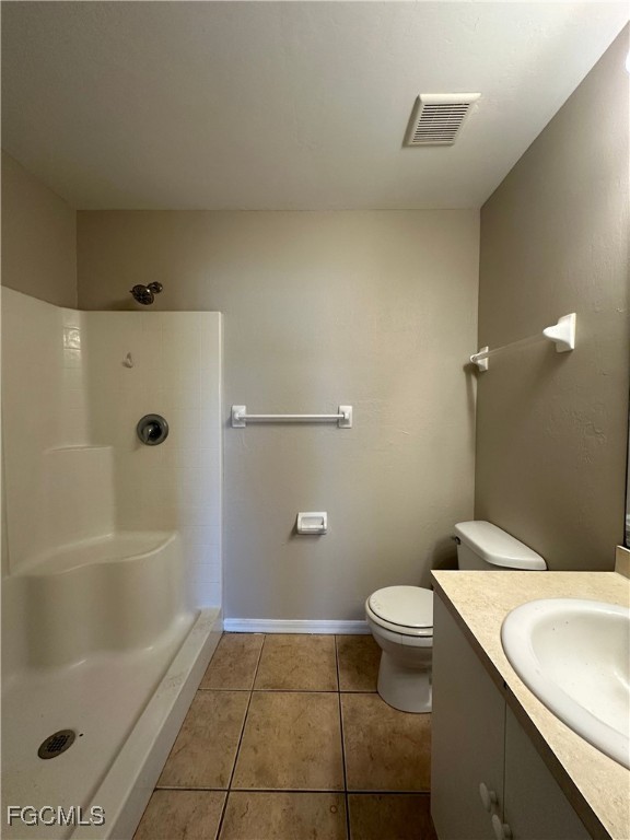 2411 Park Road, Unit 2409 Lehigh Acres, FL 33971 - Photo 11 of 20 a bathroom with a granite countertop sink a toilet and shower