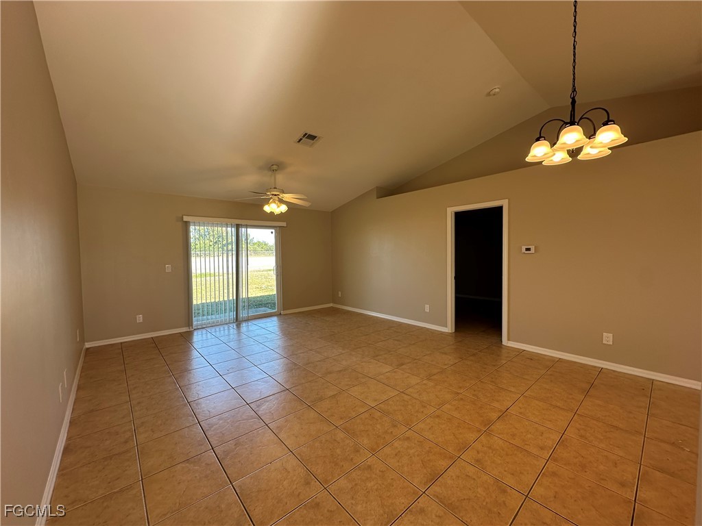 2411 Park Road, Unit 2409 Lehigh Acres, FL 33971 - Photo 8 of 20 a view of a livingroom with a chandelier fan and windows