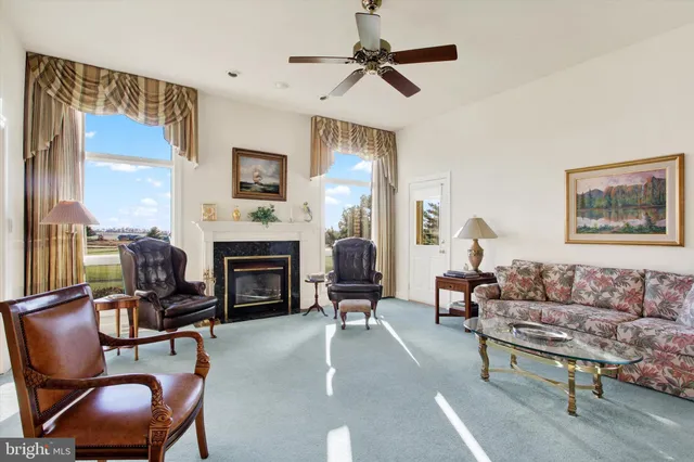 a living room with furniture a window and a fireplace