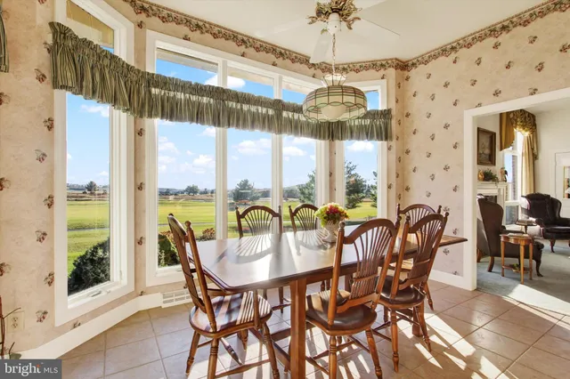 a dining room with furniture a chandelier and a rug
