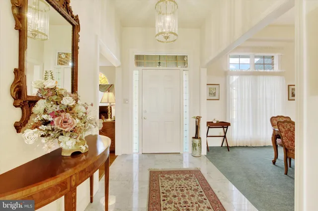 a view of a hallway to a livingroom with furniture