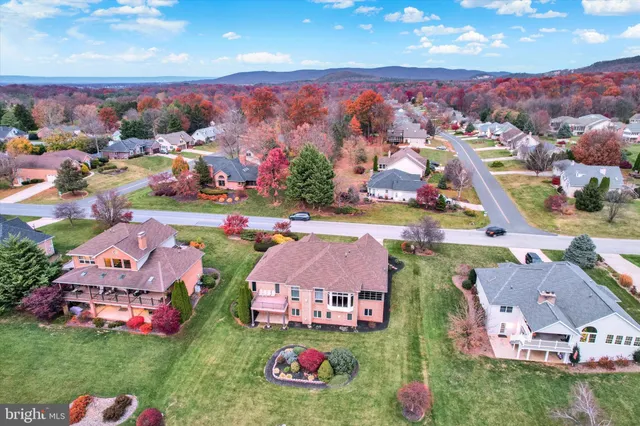 an aerial view of residential houses with outdoor space and parking