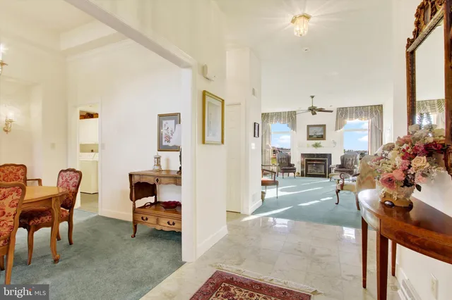 a view of a living room filled with furniture and a chandelier