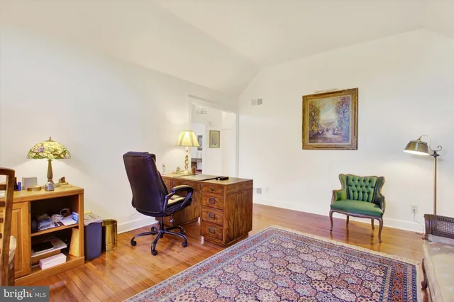 a view of a workspace with furniture and a rug