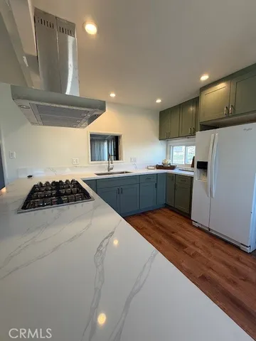 a kitchen with stainless steel appliances granite countertop a sink and a stove