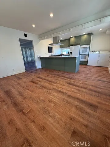a view of kitchen with cabinets and wooden floor