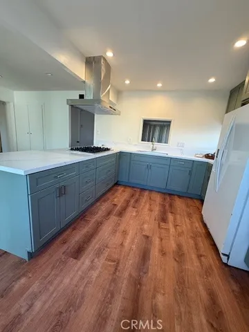 a kitchen with wooden floors and wooden cabinets