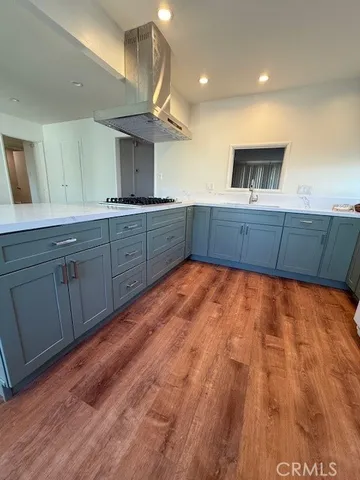 a kitchen with wooden floors and a sink