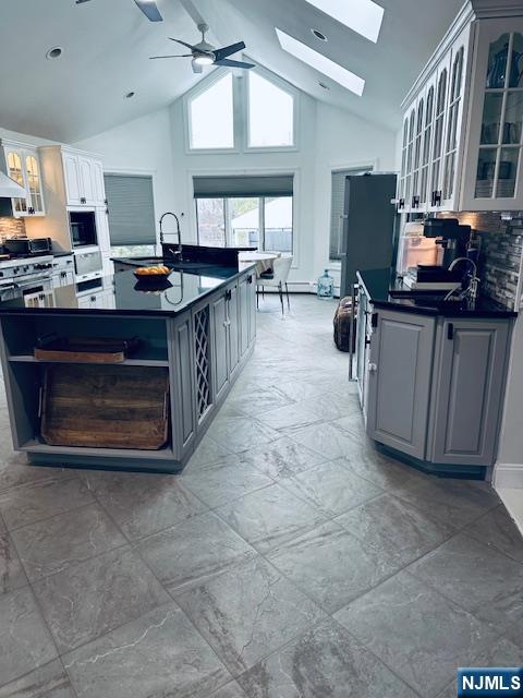 149 Oldham Road Wayne, NJ 07470 - Photo 2 of 19 a kitchen with stainless steel appliances a stove a sink cabinets and a window