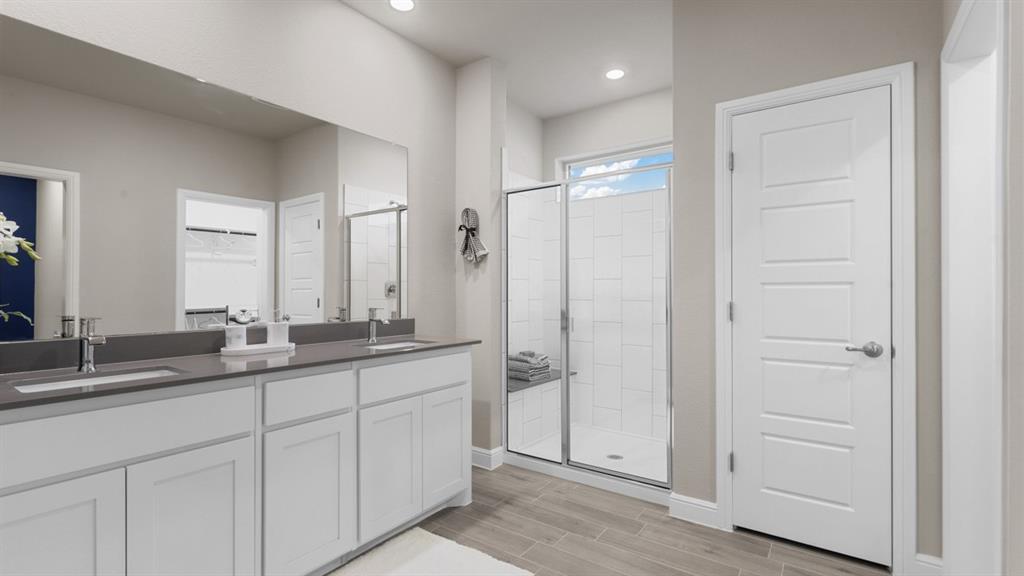 1924 Jackson Street Cleburne, TX 76033 - Photo 17 of 34 a bathroom with double sink and a mirror