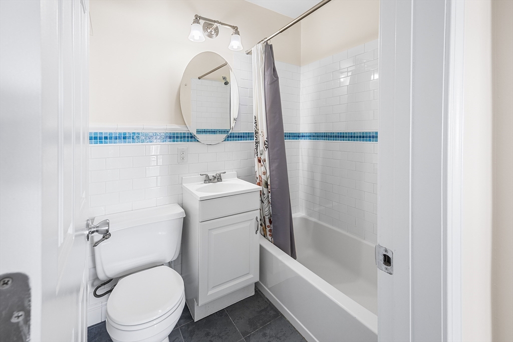 4 Commonwealth Court, Unit 20 Boston, MA 02135 - Photo 11 of 22 a bathroom with a sink a toilet and a mirror