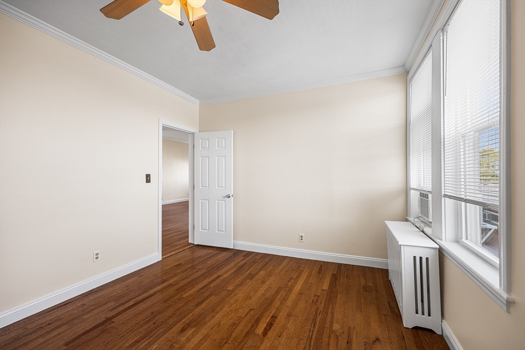 4 Commonwealth Court, Unit 20 Boston, MA 02135 - Photo 12 of 22 an empty room with wooden floor and windows