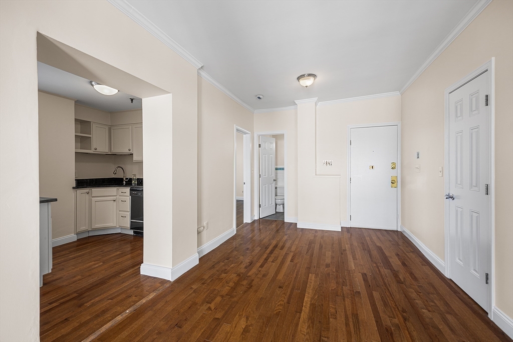 4 Commonwealth Court, Unit 20 Boston, MA 02135 - Photo 6 of 22 a big room with wooden floor and kitchen