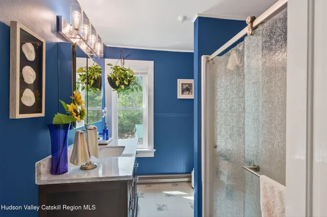 a view of a hallway with furniture and a potted plant