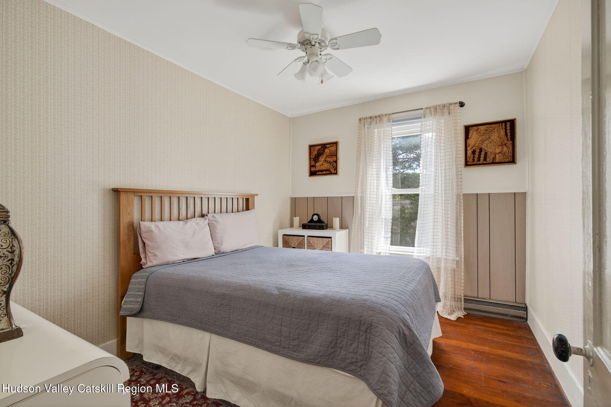 8213 Main Street Hunter, NY 12442 - Photo 18 of 44 a bedroom with a large bed and a chandelier