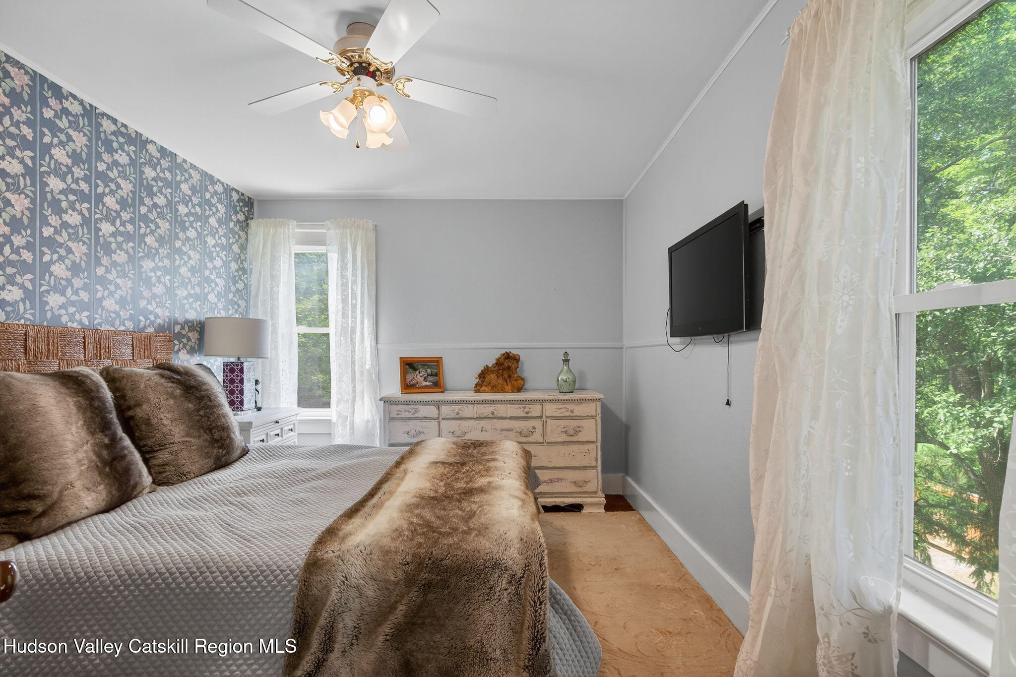 8213 Main Street Hunter, NY 12442 - Photo 19 of 44 a bedroom with a bed and a flat screen tv