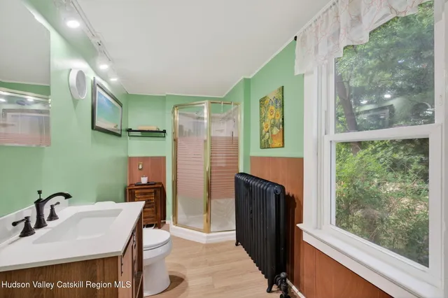 a bathroom with a sink a toilet and a mirror