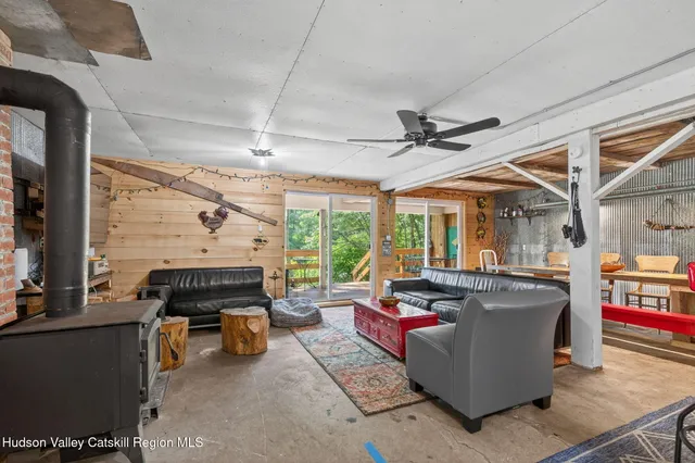 a living room with fireplace furniture and a large window