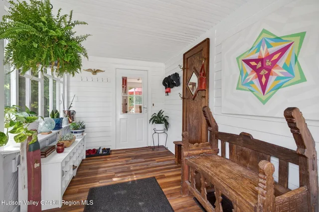 a living room with furniture stairs and a potted plant