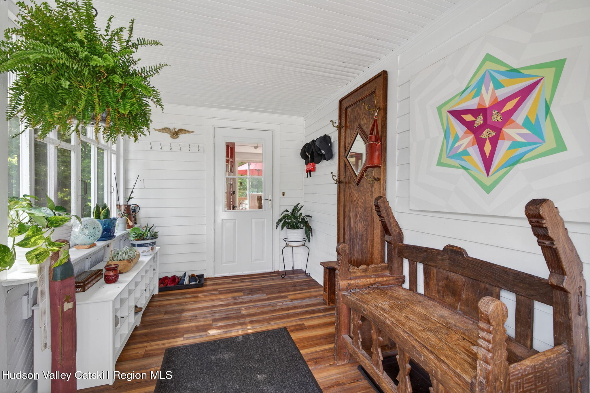 8213 Main Street Hunter, NY 12442 - Photo 3 of 44 a living room with furniture stairs and a potted plant