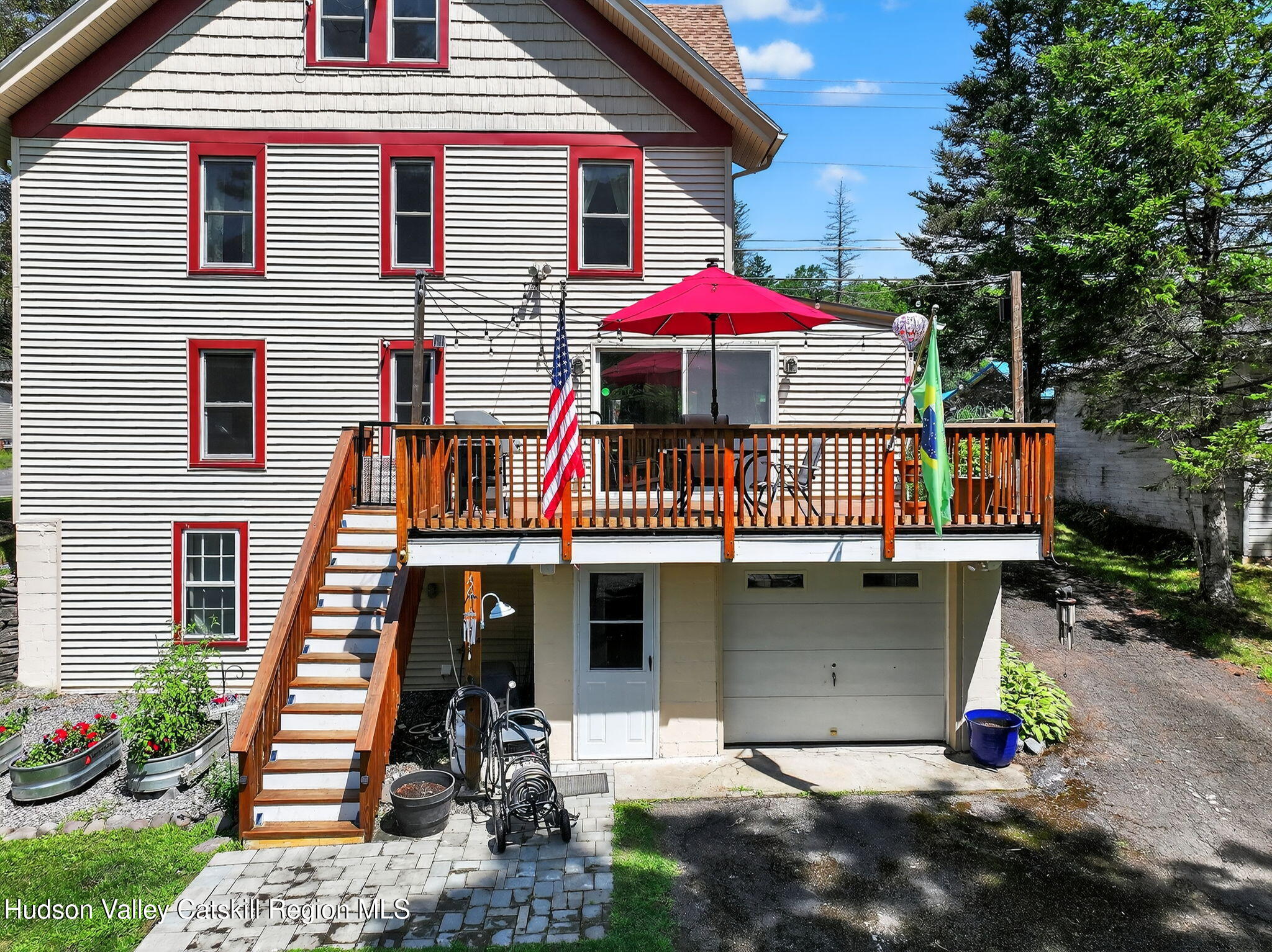 8213 Main Street Hunter, NY 12442 - Photo 36 of 44 a front view of a house with porch and garden