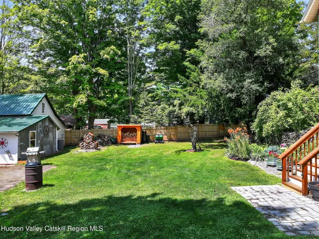 a view of a house with backyard porch and sitting area