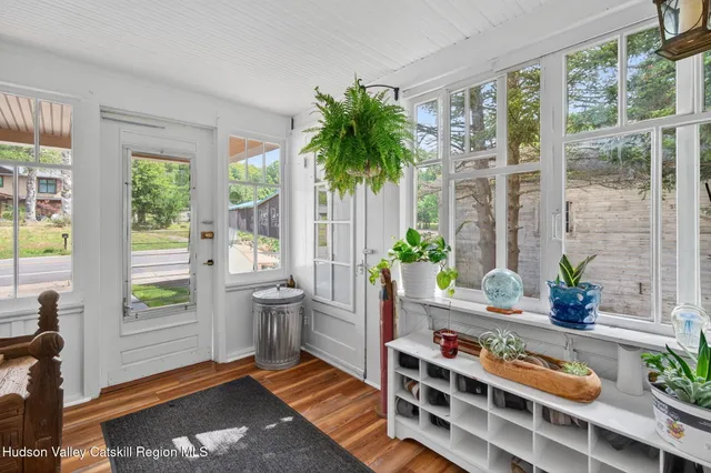 a living room filled with furniture and a potted plant
