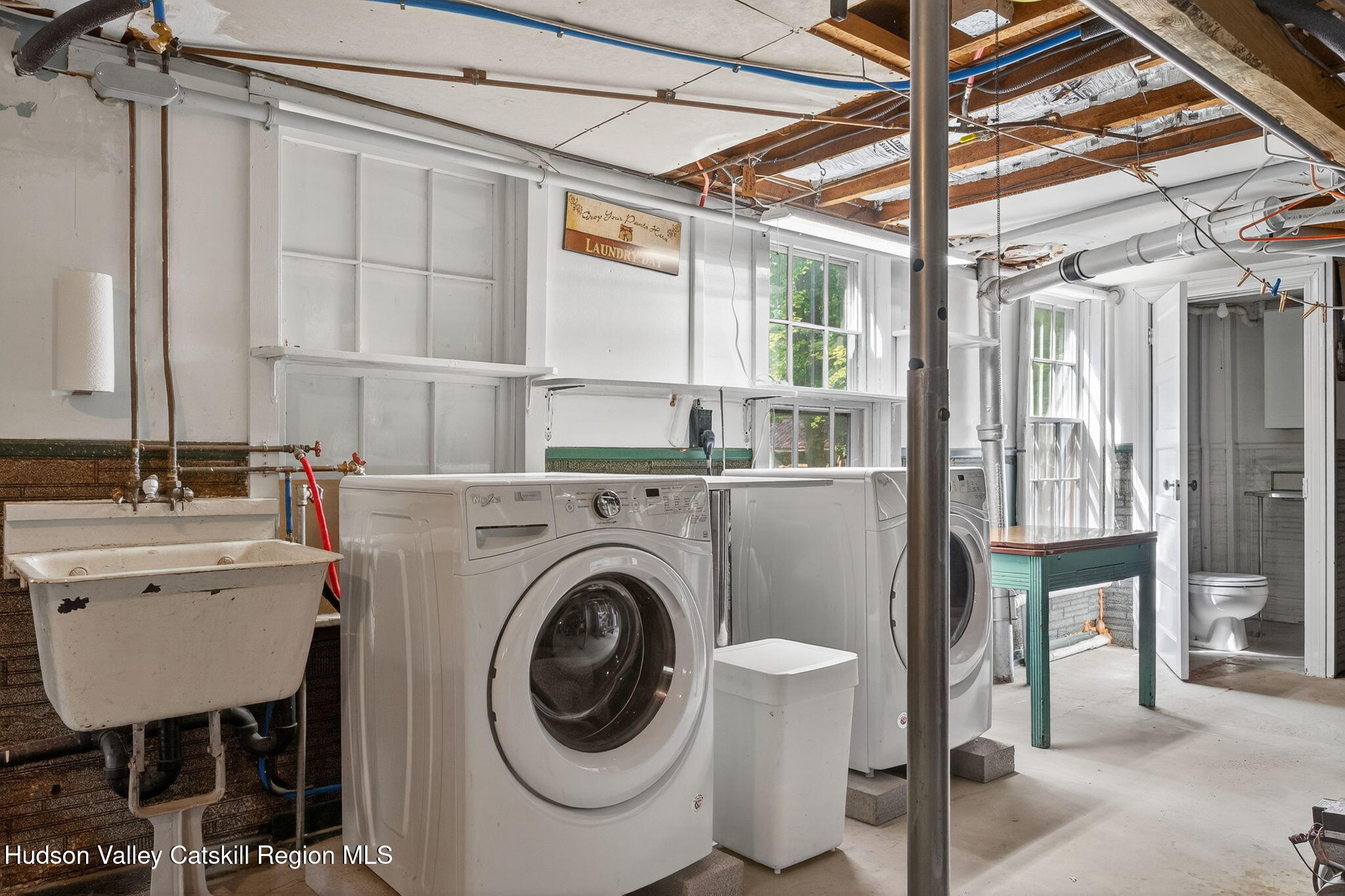8213 Main Street Hunter, NY 12442 - Photo 41 of 44 a bathroom with a sink a mirror and a bathtub