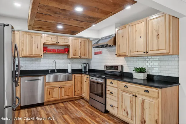 a kitchen with stainless steel appliances granite countertop a stove sink and cabinets