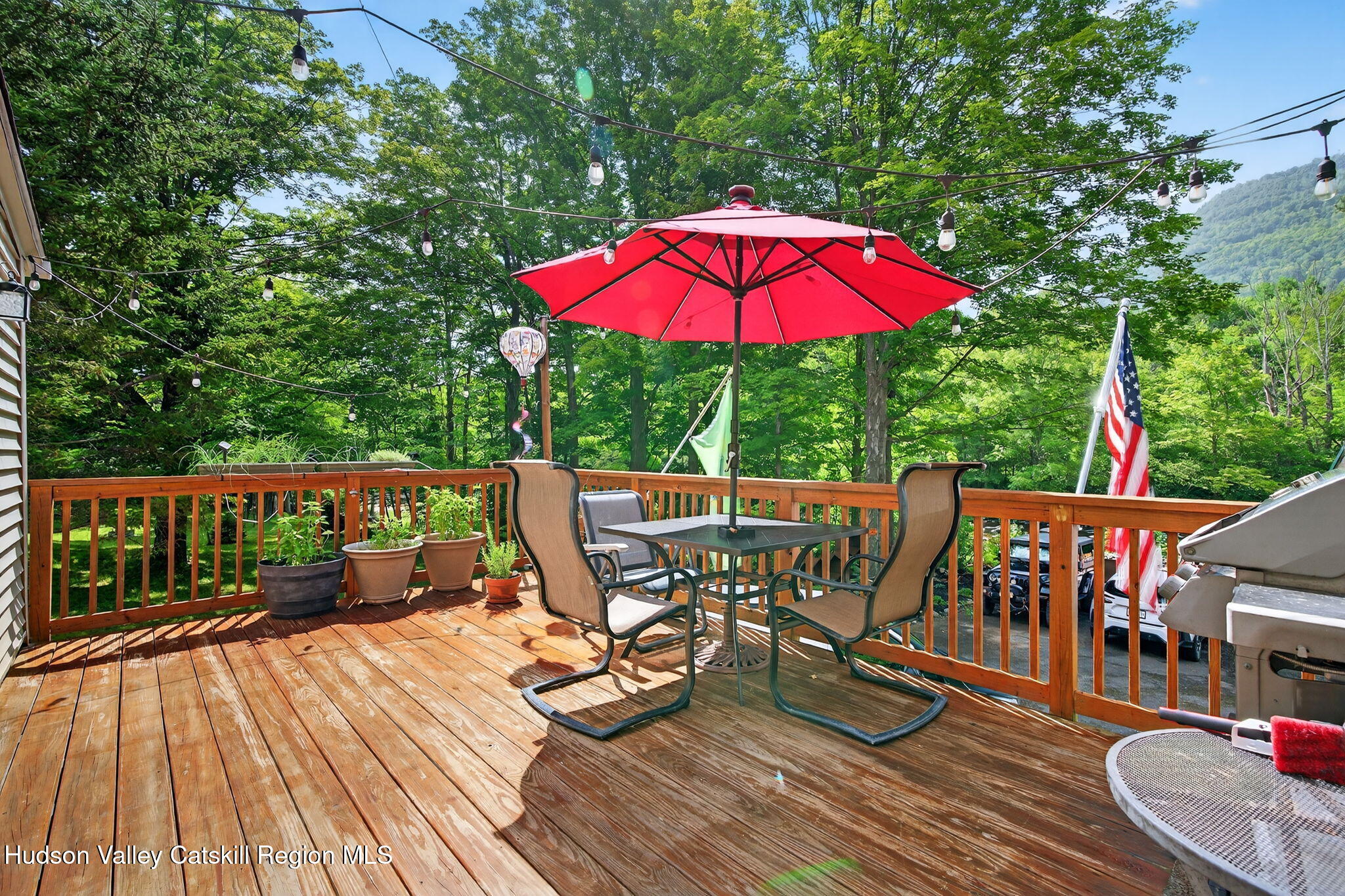 8213 Main Street Hunter, NY 12442 - Photo 9 of 44 a view of balcony with outdoor seating and wooden floor