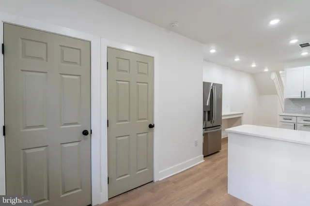 a kitchen with a refrigerator and a sink
