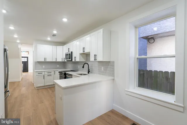 a kitchen with a sink stove and refrigerator