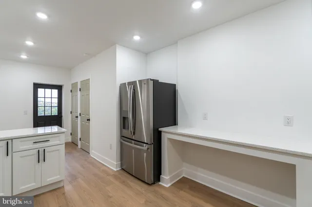 a kitchen with a refrigerator and a sink