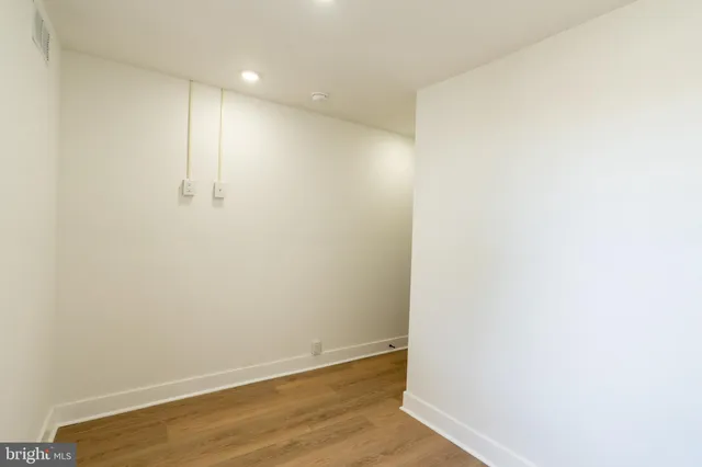 a view of water heater room with wooden walls