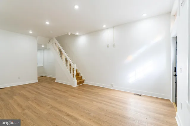 a view of an empty room with wooden floor