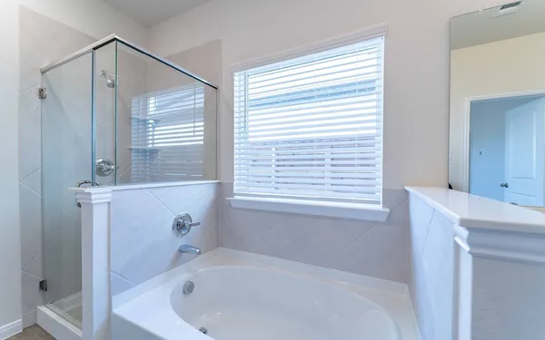 a white bath tub sitting next to a white sink