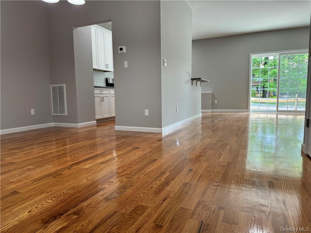 Unfurnished room with hardwood / wood-style flooring