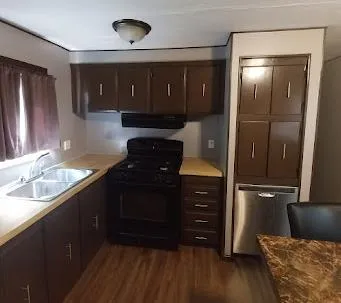 a kitchen with a refrigerator and a sink