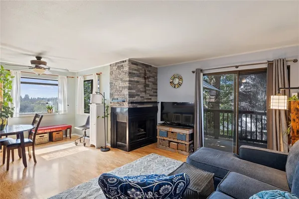 a living room with furniture a flat screen tv and large window