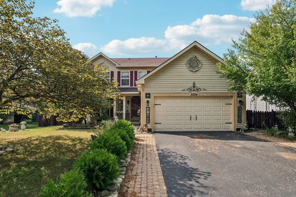 a view of a house with a yard and garage
