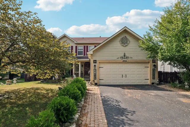 a view of a house with a yard and garage