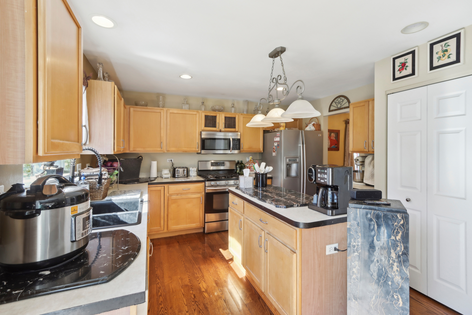3304 Alyssa Street Plano, IL 60545 - Photo 12 of 30 a kitchen with stainless steel appliances granite countertop a stove top oven a sink a counter space and cabinets