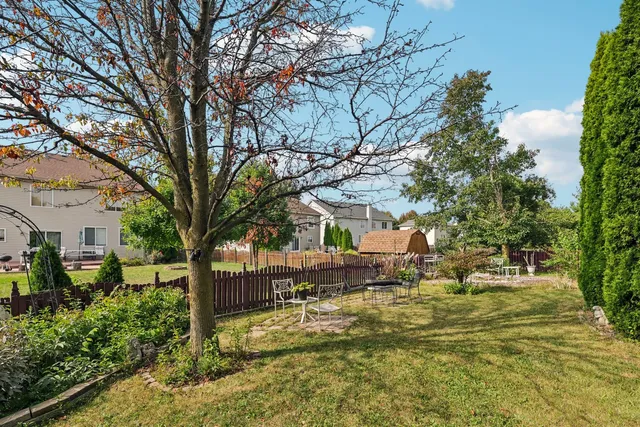 a backyard of a house with barbeque oven and outdoor seating
